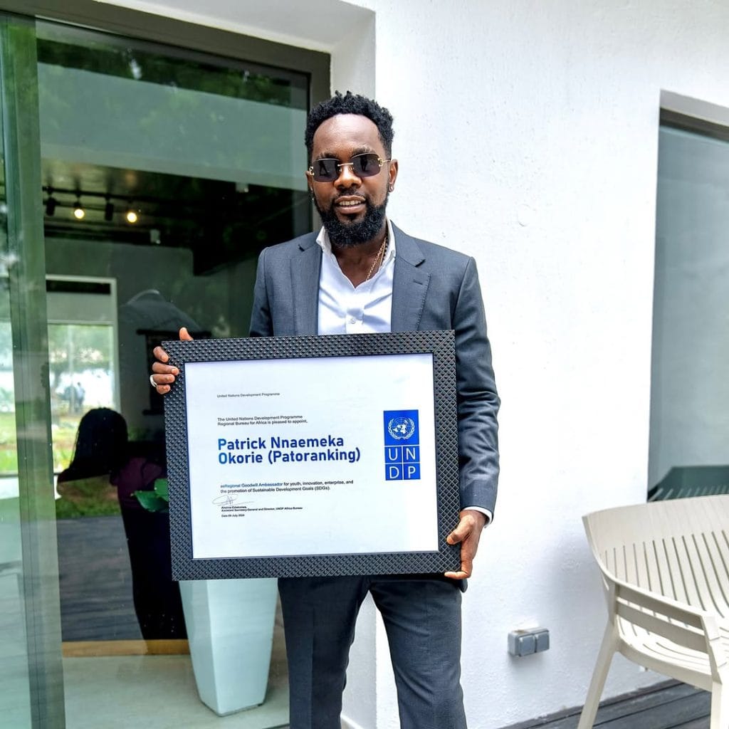 Patoranking, Nigerian reggae-dancehall artist and one of the richest musicians, smiling in a stylish outfit